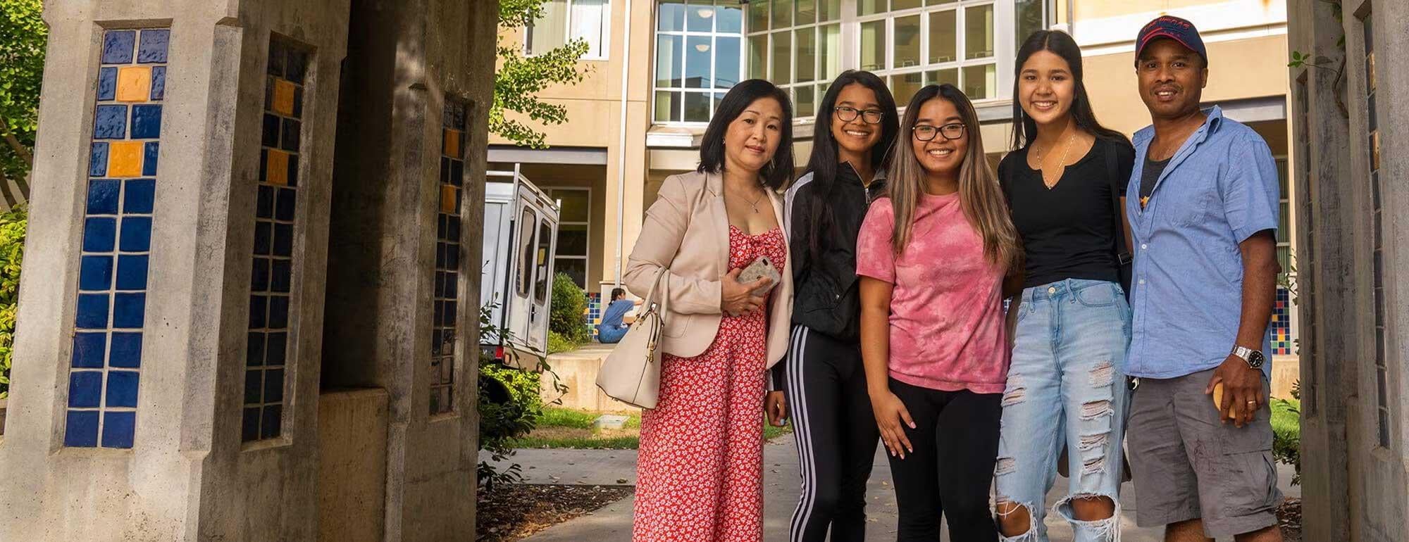Family posing together on UC Davis campus