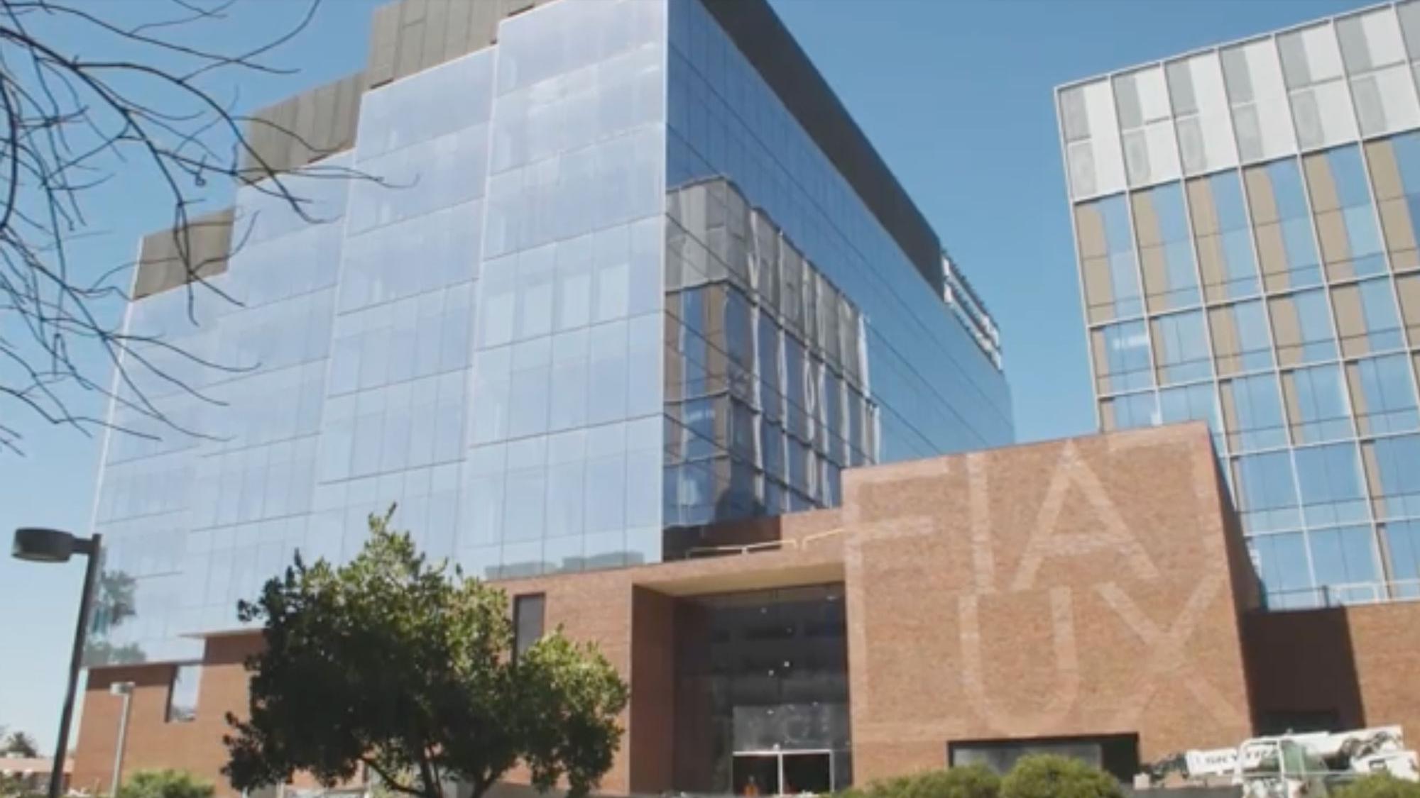 An exterior shot of a mirror glass skyscraper