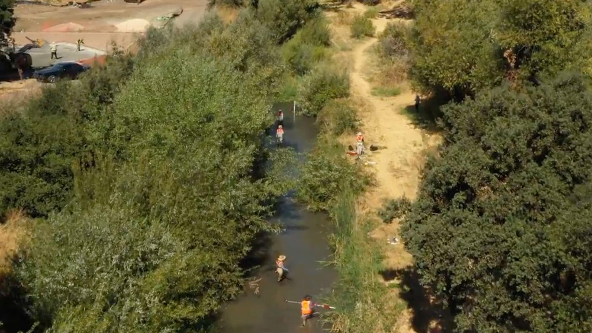 Aerial view of people doing surveys in a river