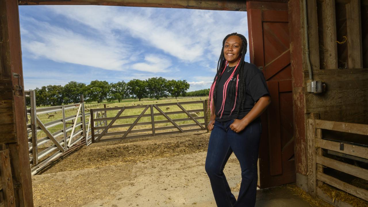 student standing in barn entrance