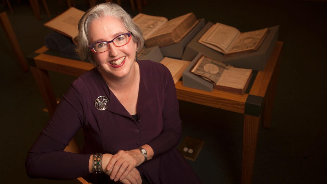 Fran Dolan portrait, with open books in background.