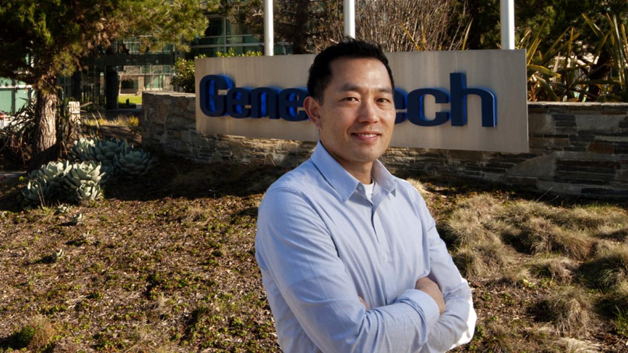 Mike Chan standing in front of sign