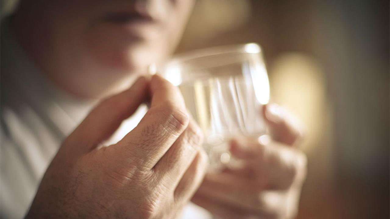 closeup of a person taking a pill