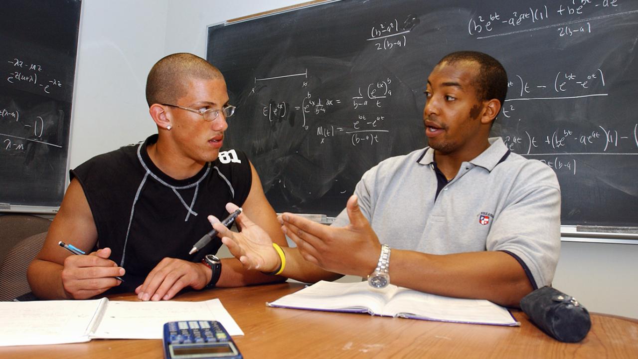 Biochemistry and molecular biology major Chris Jones, right, tutors Brandon Rice in chemistry
