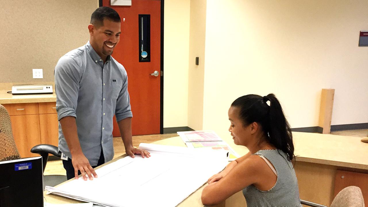 Community and regional development major Nick Sosa, right, works with a college in the city of Rancho Cordova