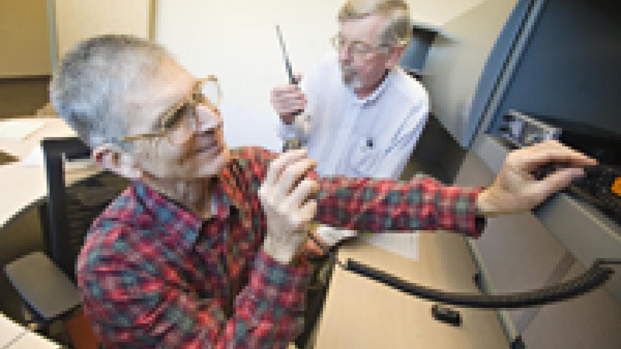 Gary Matteson, foreground, a researcher in biological and agricultural engineering, prepares to perform a radio check with members of the newly established amateur radio group at UC Davis. Listening in is John Berg, a lab manager in chemistry wh