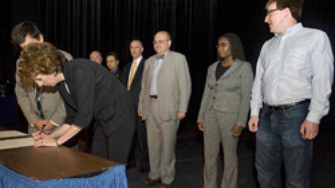 In reaffirming the Principles of Community, Chancellor Linda Katehi signed first, to be followed by Enrique Lavernia, provost and executive vice chancellor, standing beside Katehi; and, behind them, from left: Rick Hom, chair, Staff Assembly, Sa