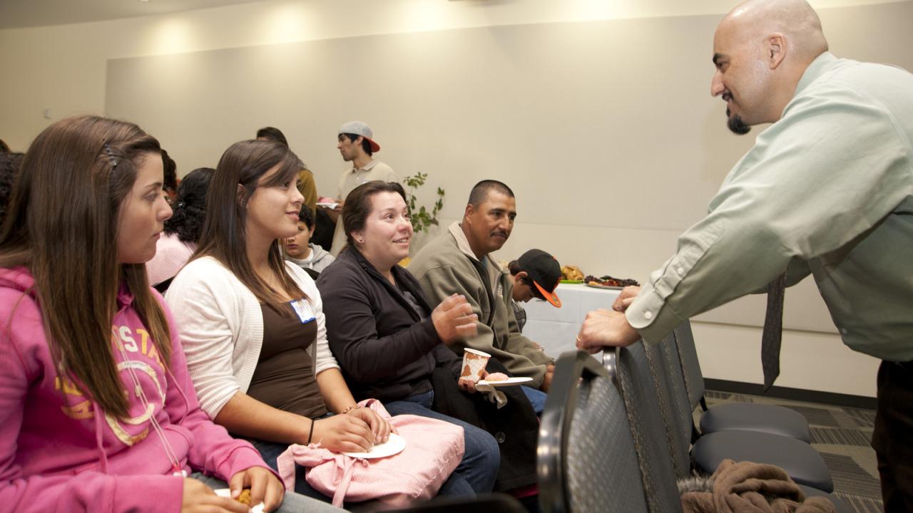 Sam Blanco talks with a family at Decision UC Davis