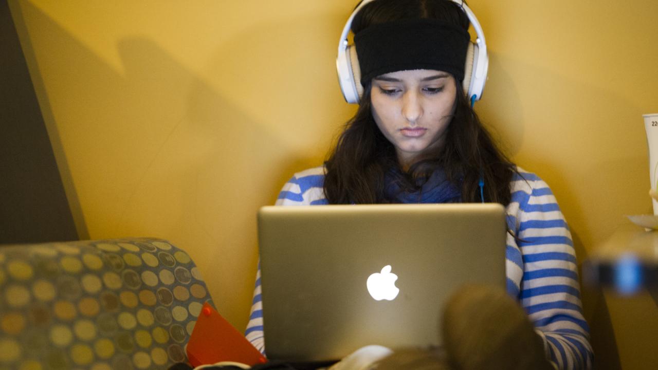 A female student looks at her laptop
