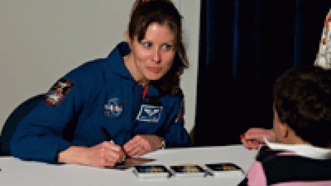 Tracy Caldwell, a NASA astronaut and UC Davis alumna, signs autographs after giving a Jan. 25 lecture on campus. 
