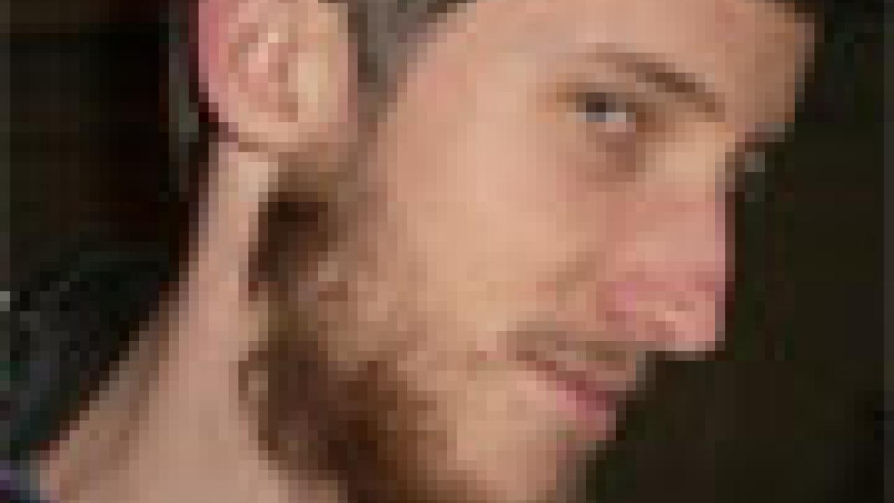 photo: man with headphones on neck