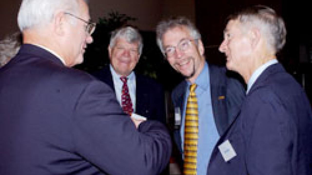 Jerry Fielder Memorial Awardee Karl Gerdes, second from right, talks with Wayne Bartholomew, left, and colleagues from chemical engineering and materials science &mdash; professor emeritus Richard Bell and professor Alan Jackman &mdash;  at the CAAA cer