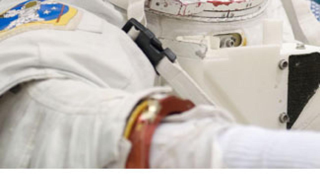 Photos: Dyson in her spacesuit for a training session. Dyson and Wheelock prepare spacesuits in the Quest airlock, on board the space station.