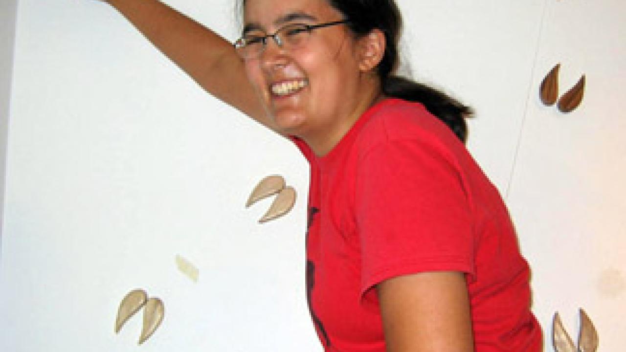 Catherine Yasuda installs hand-shaped mule deer footprints for her exhibition, Odocoileus hemionus (mule deer), at the Craft Center Gallery.