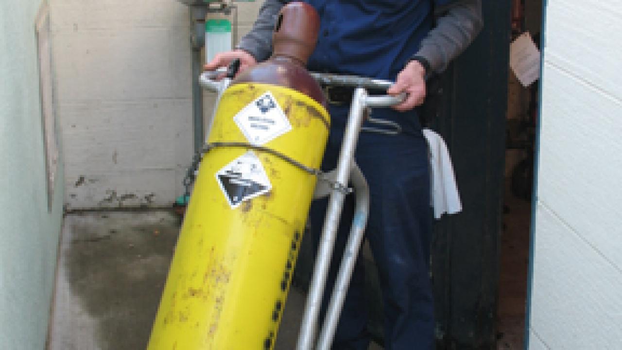 Swimming pool operator Kirk Schaake carts off one of the last chlorine gas tanks from Hickey Pool on Feb. 7.