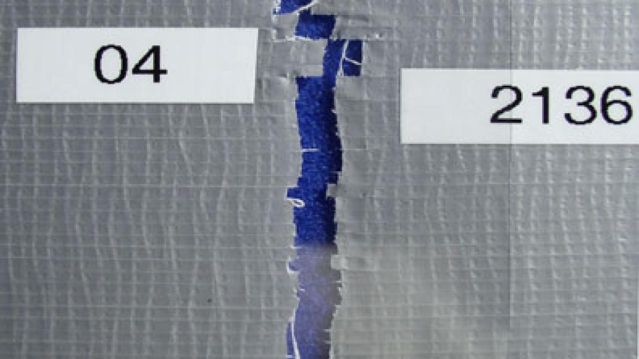 The open seam between two pieces of duct tape, the pieces having formerly been attached, to show how the pieces might be reliably matched.