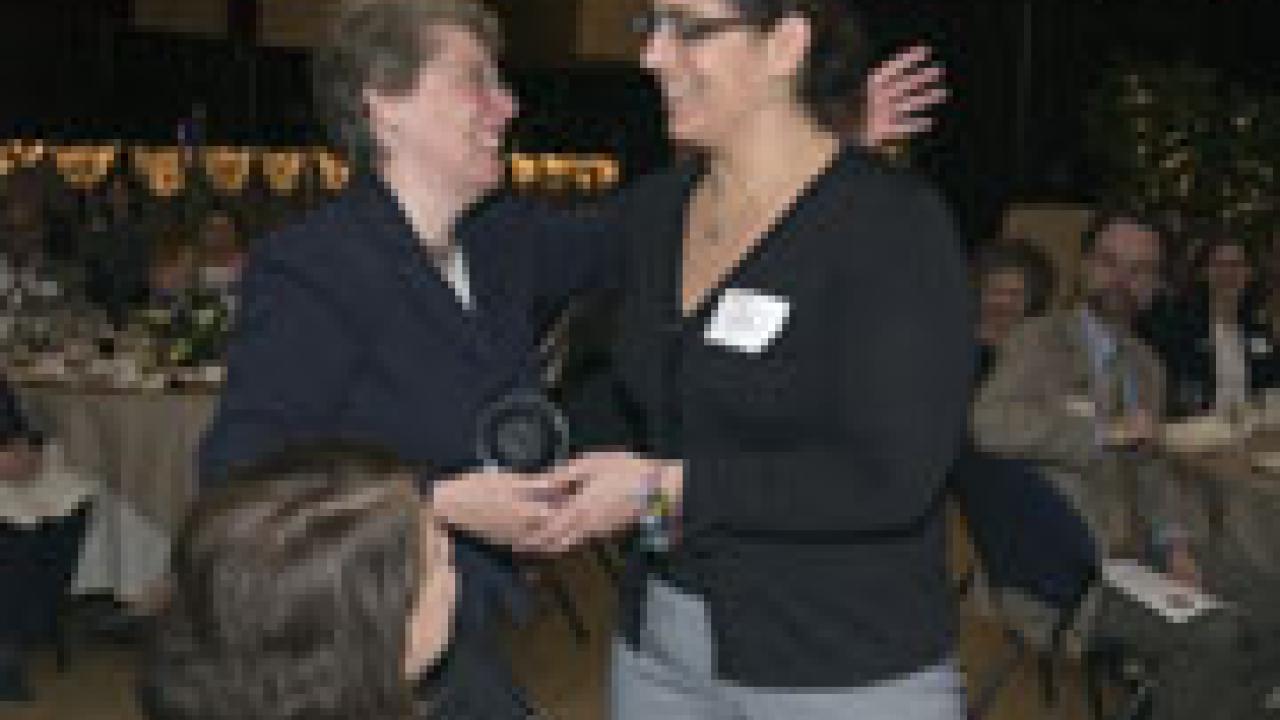 Claire Pomeroy, vice chancellor for human health sciences and dean of the School of Medicine, makes a presentation to Karen Charney, executive directo