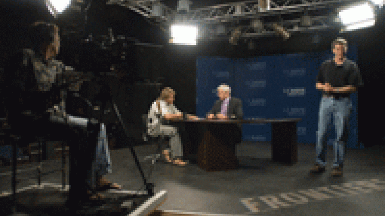 Chemist Matthew Augustine, left, talks with Paul Pfotenhauer, Frontiers host and producer, as they prepare for an interview on Augustine&rsquo;s  liquid explosives research.