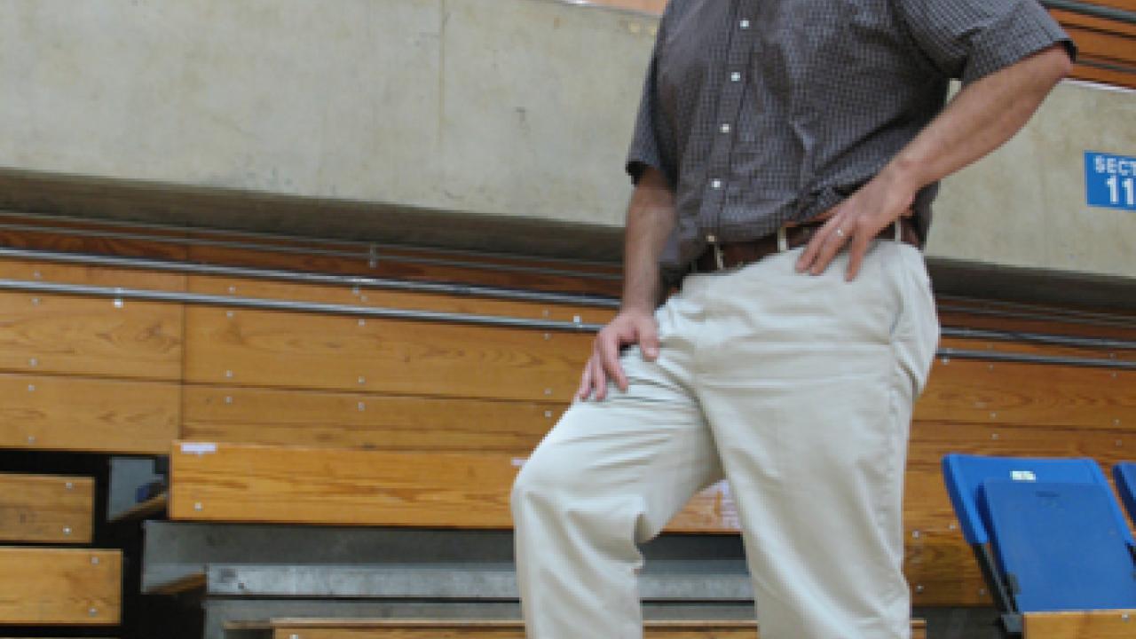 Matt Fucile stands below the concrete wall that workers will cut through through to allow for aisles from the floor to the upper concourse.