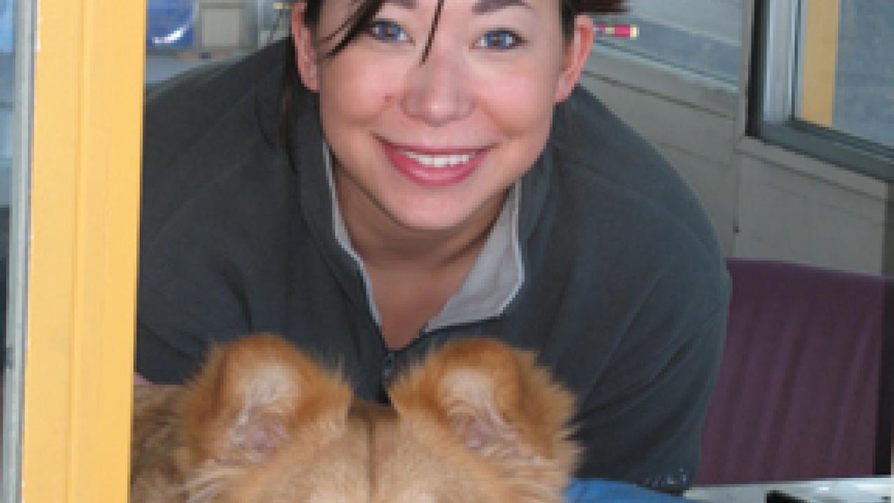 Student employee Jennifer Cheng and her dog, Keira, at the North Gate Kiosk.