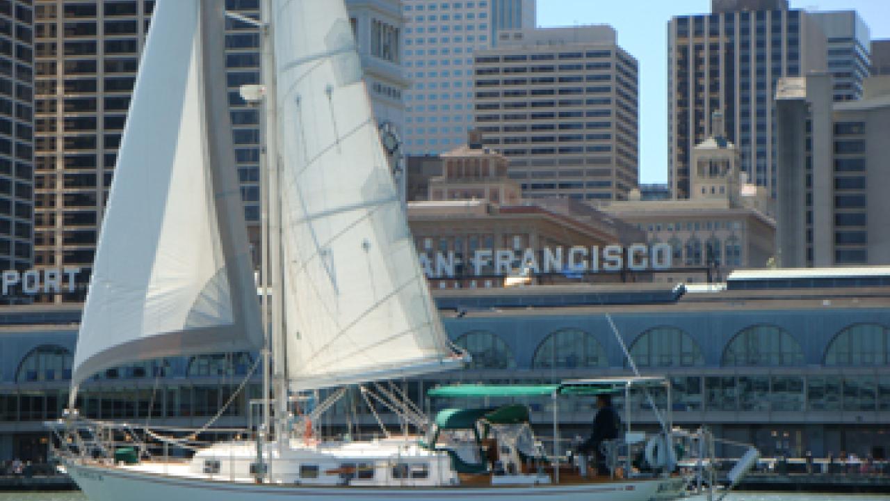 UC Davis' Kokua III sails past the San Francisco Ferry Building.
