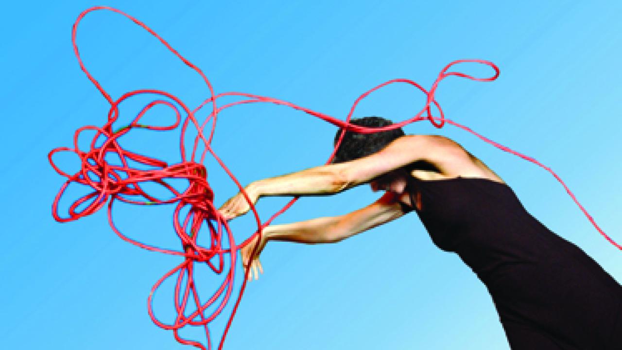 Nina Galin twirls an extension cord, representing institutionalization, in the Main Stage Theatre-Dance Festival's Life Among the Institutions.