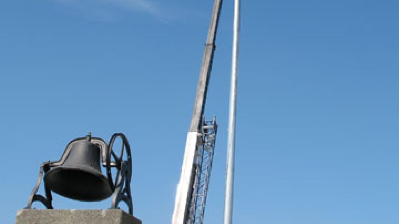 A crane lowers one of the light poles into place on May 29 at Aggie Stadium, where the Tavernetti Bell greets fans entering from the east.
