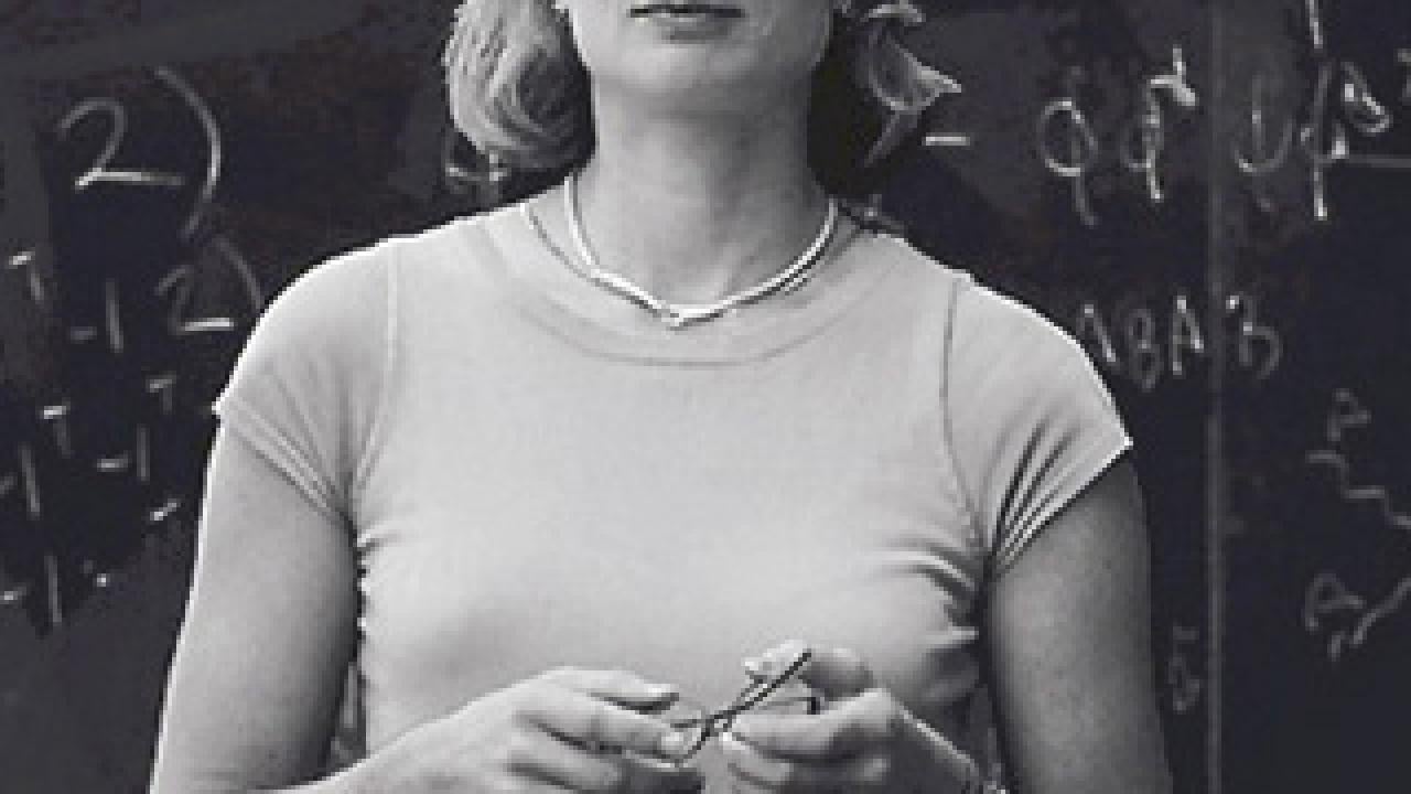 Woman standing in front of blackboard