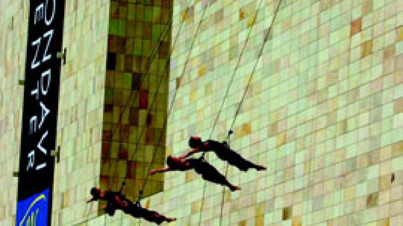 Photo: Project Bandaloop performs aerial acrobatics on the Mondavi Center's south wall in the finale of ribbon-cutting ceremony, Oct. 3, 2002.