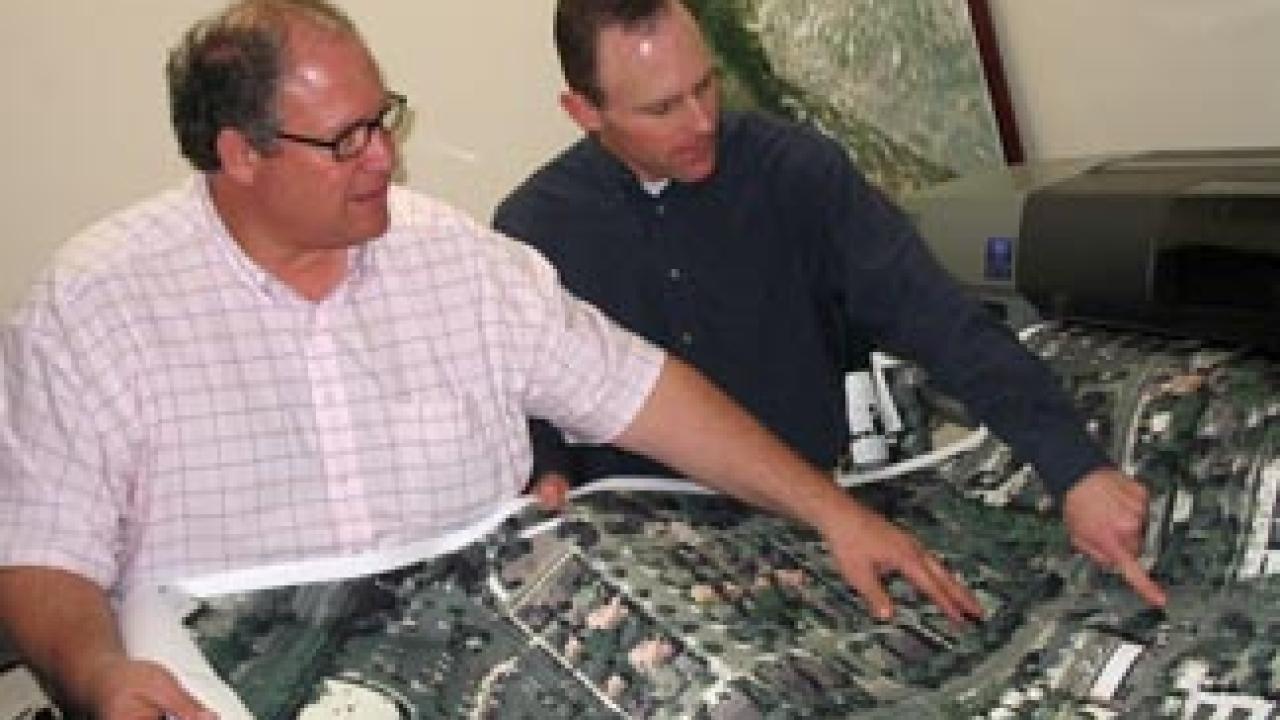 Printing the map: Chris Didio, left, geographical information system analyst, and planner Matt Dulcich examine one of the 18 sections, each 10 feet lo