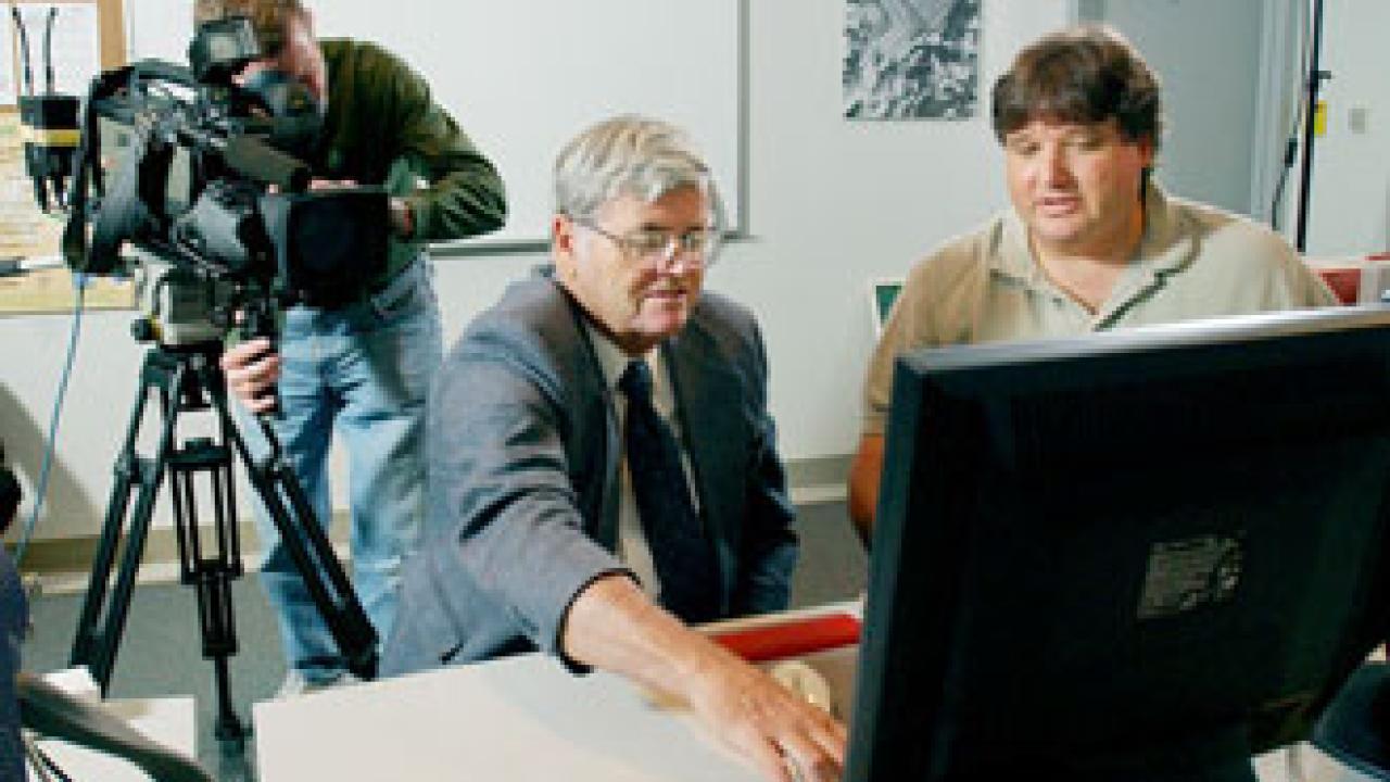 An NBC news crew works with Thomas Cahill (middle) last week on campus, reviewing his Ground Zero research.