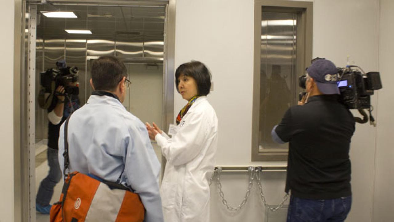 Lisa Miller, associate professor, School of Veterinary Medicine, talks with a news reporter.