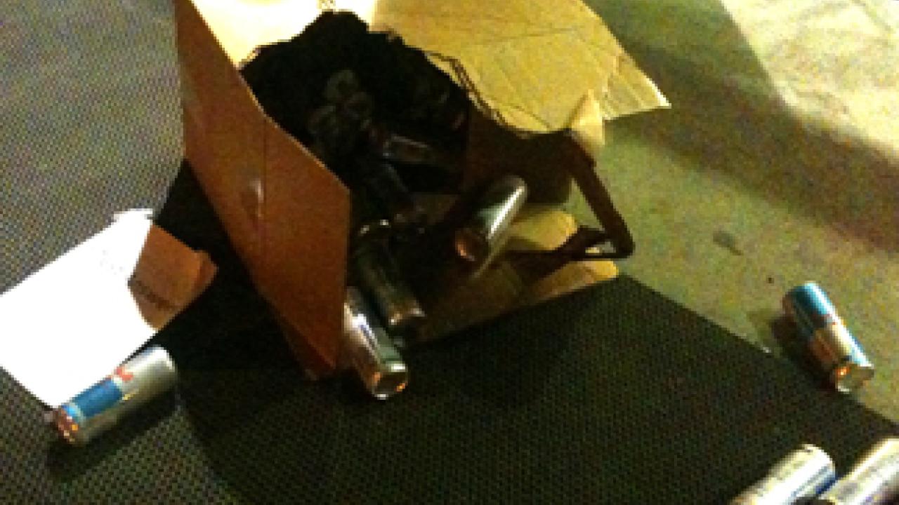 Cans of energy drink spill out after a bomb squad robot opened the box. The box came with a note attached, with this phrase: "Test Answers."