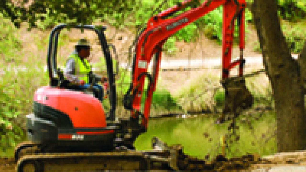 A new path and circular seating area take shape along the arboretum waterway.
