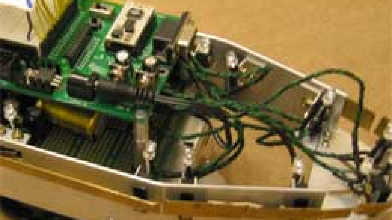 Photo: Part of a motorized vehicle with many wires