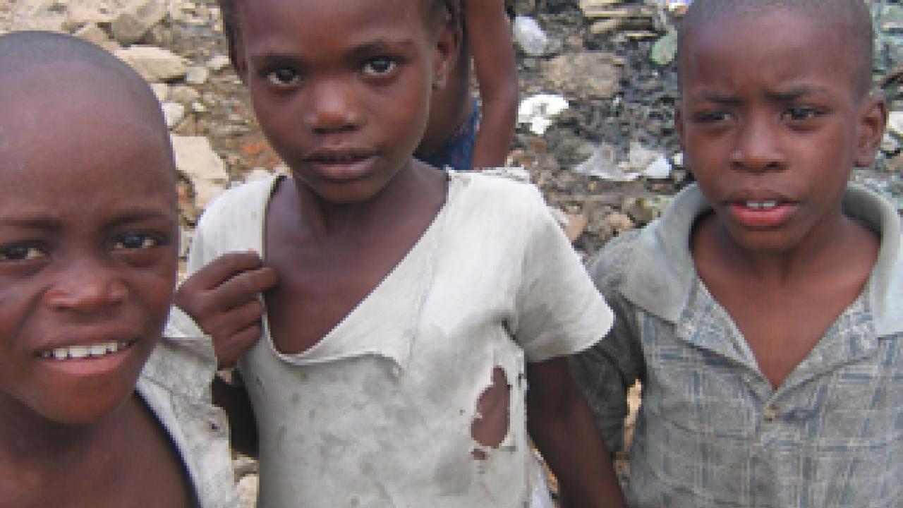 Children next to a pink pond in Shada, Haiti.