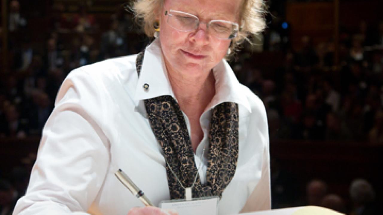Photo: Vice Provost Maureen Stanton signs the Book of Members as part of her induction Oct. 6 into the American Academy of Arts and Sciences.