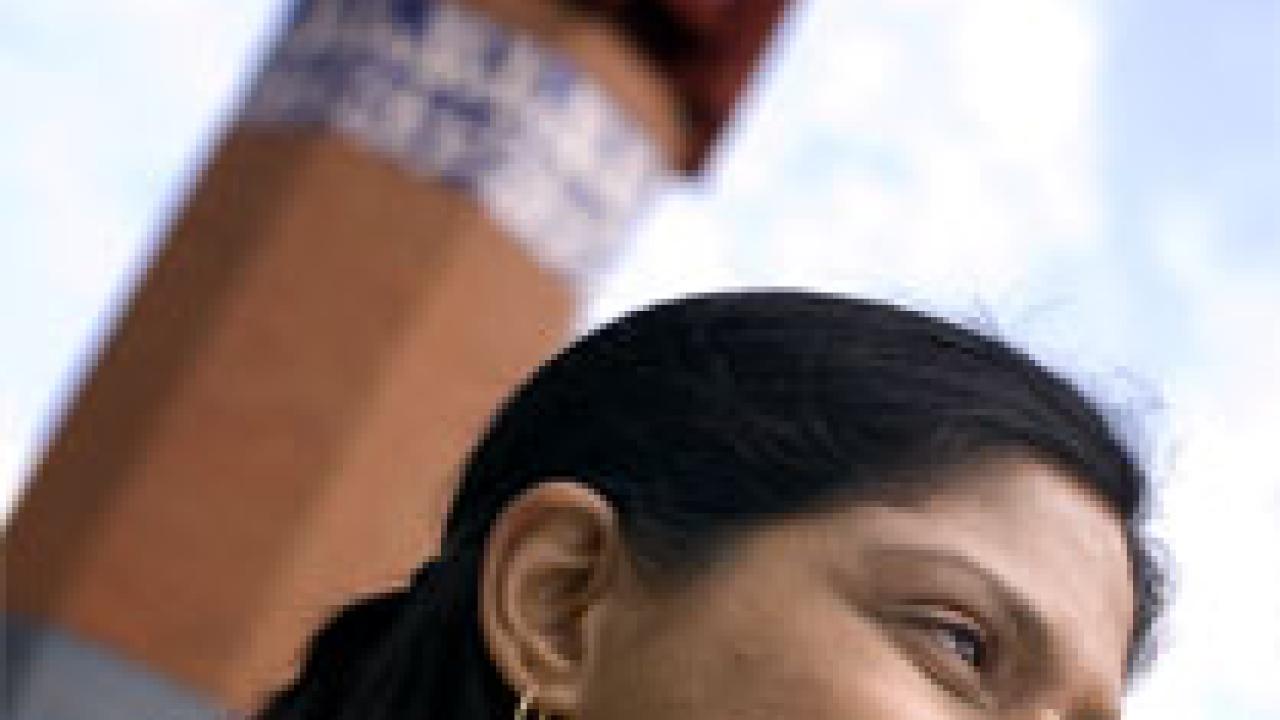 Photo: woman's profile with mosque in background