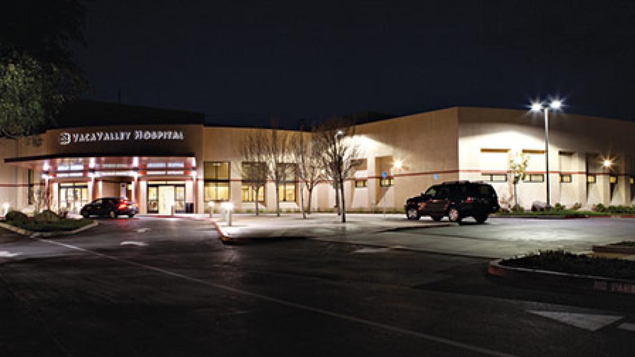 Outside of hospital at night showing the lighting for parking