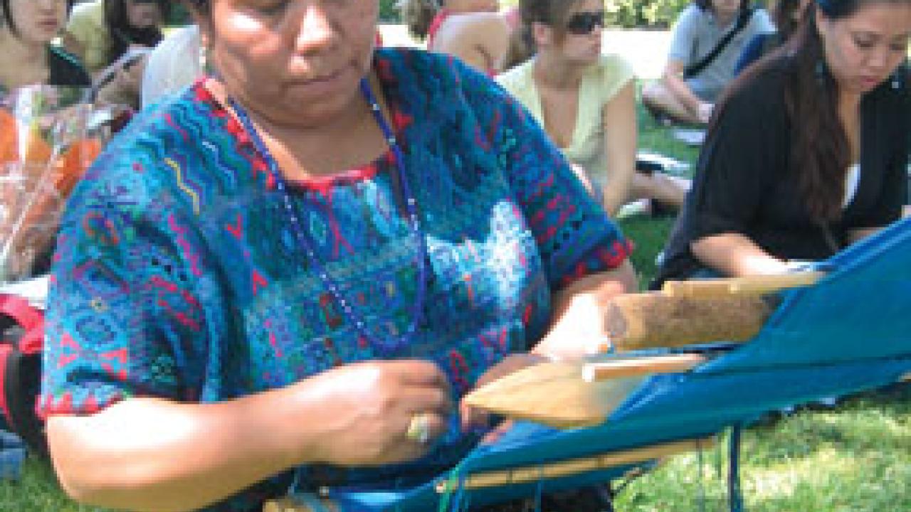 Bertina Lopez de Martin demonstrates the making of weft brocade fabric, which is used in the huipil, a traditional blouse for Mayan women.