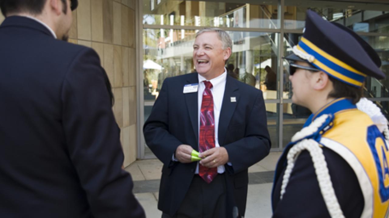 Photo: Student Affairs Vice Chancellor Fred Wood chats with members of the Cal Aggie Marching Band-uh! during Fall Convocation 2008.