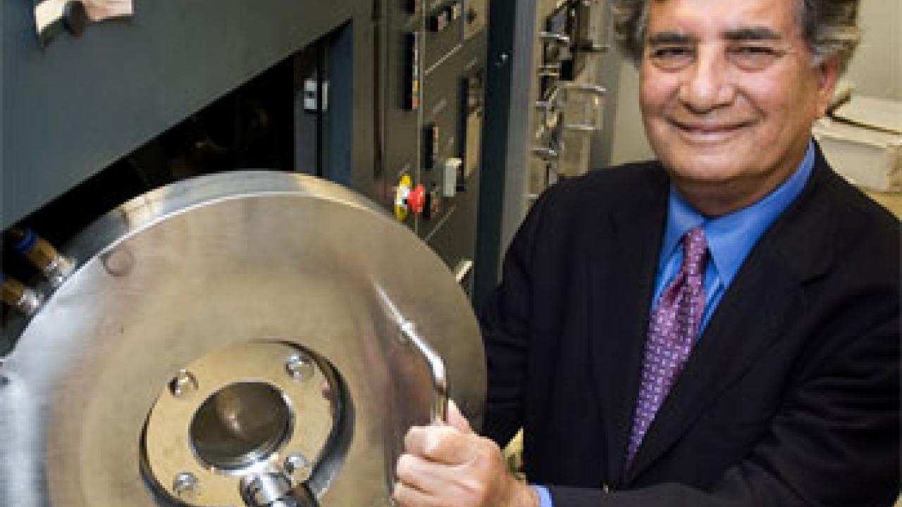 Photo: Man opening a door to lab machine