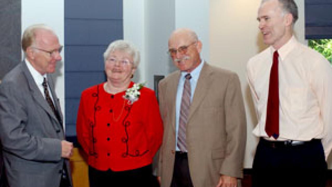 Chancellor Larry Vanderhoef honors Academic Federation Awards for Excellence recipients Dorothy Fraser, William Reisen and Jared Haynes.
