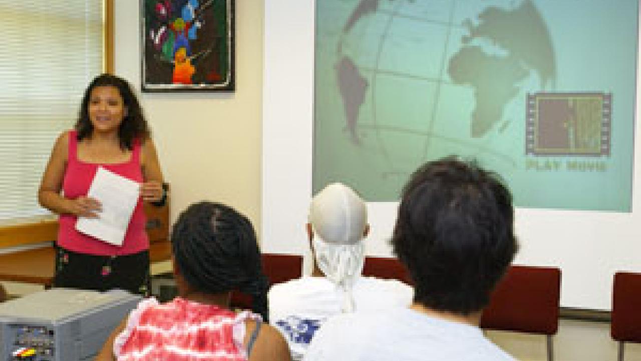 Christine Acham leads her Black Documentary: Theory and Practice class before a standing room only crowd in Hart Hall. Several dozen students, staff and faculty members assembled last spring to watch movies students had, over the course of a qua