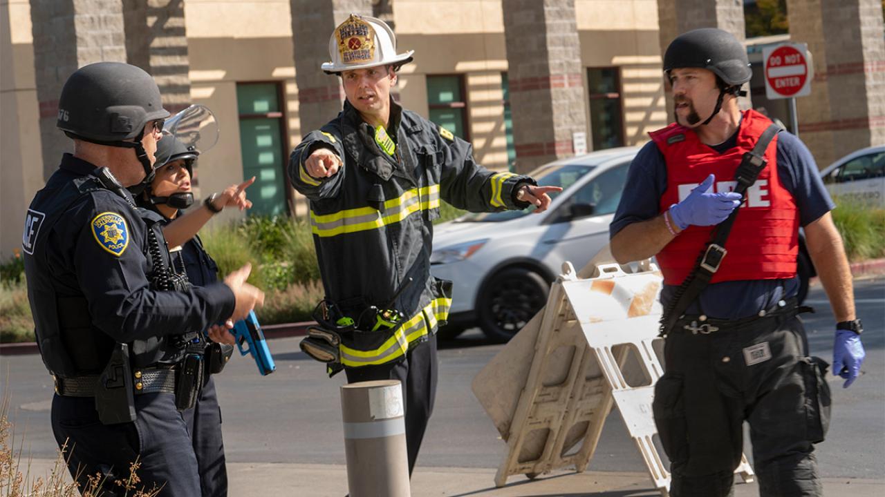 Police and firefighters talk during an emergency exercise.
