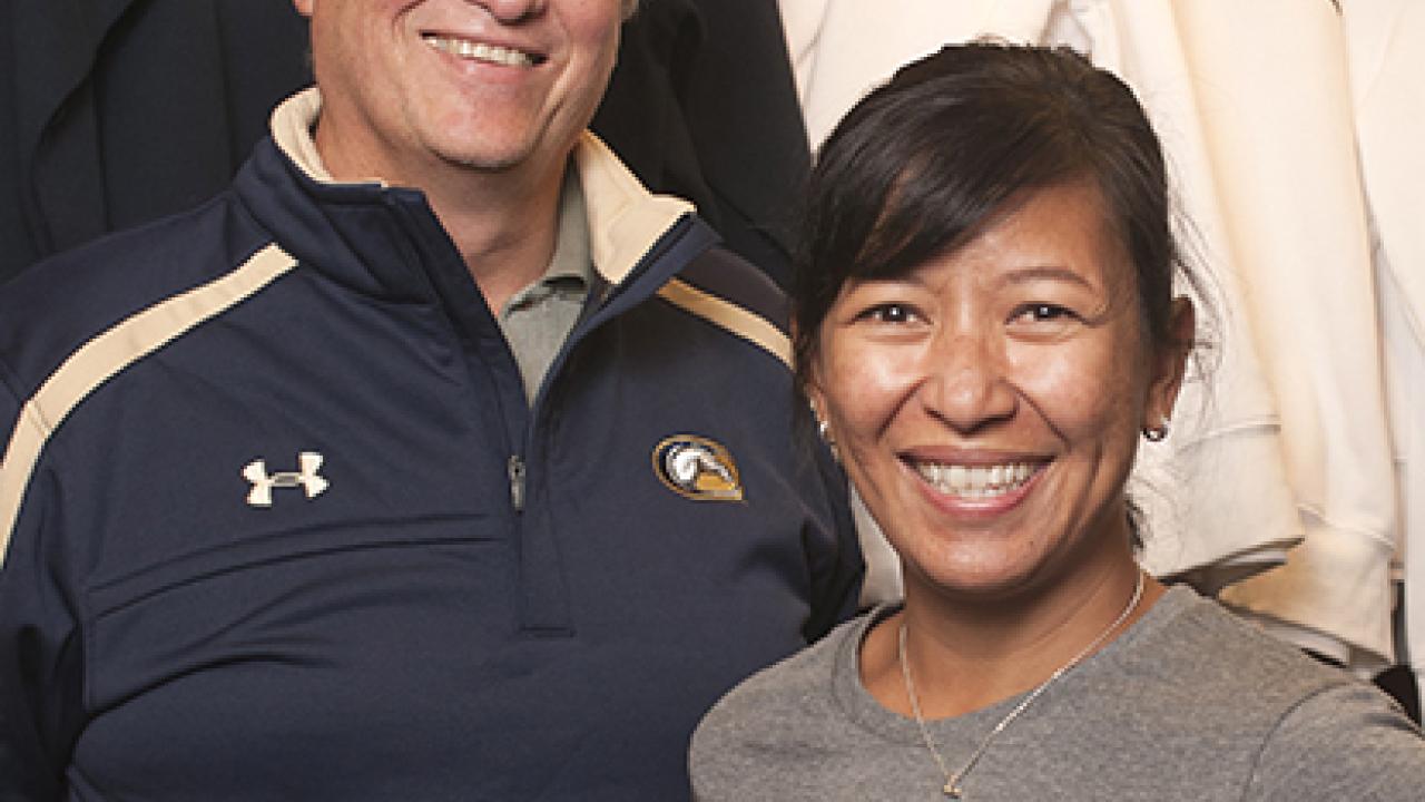 Photo: Professor Andr&eacute; Knoesen, vice chair, Academic Senate; and Lina Layiktez, chair, Staff Assembly &mdash; both wearing Aggie gear.