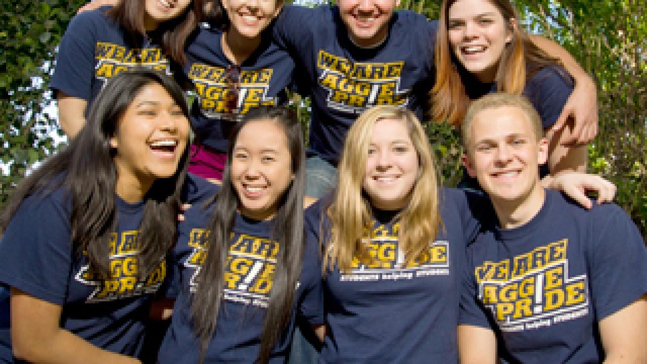 Group of students in two rows with We Are Aggie Pride! T-shirts
