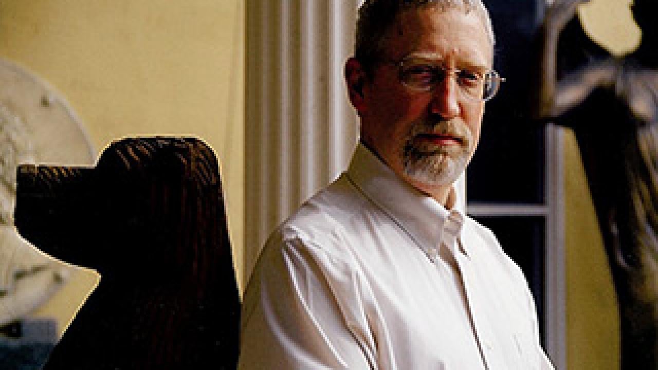 Portrait of Alan Taylor with a dog statue 