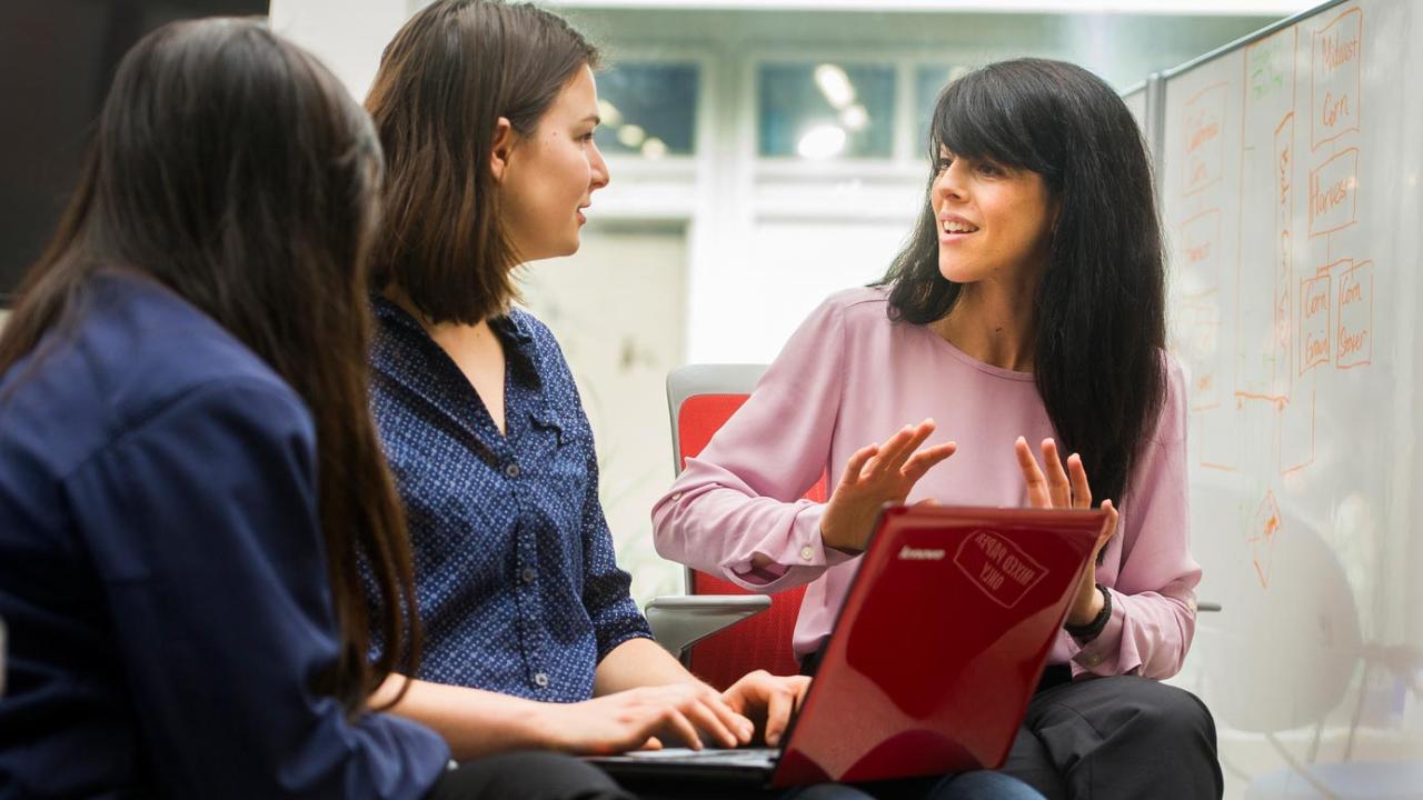 Engineering professor, right, explains to her two female graduate students.