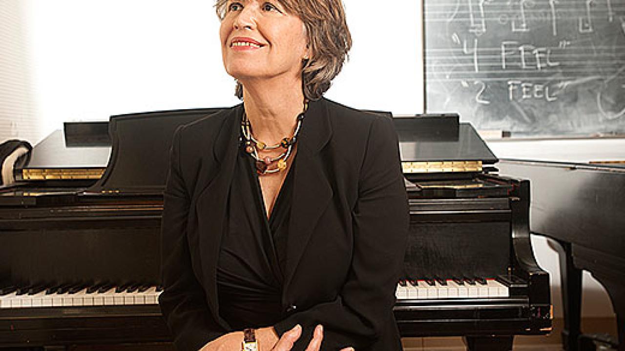 Anna Maria Busse Berger sitting at piano